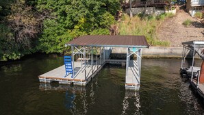 Eine Anlegestelle mit überdachter Sitzgelegenheit und einem Boot.