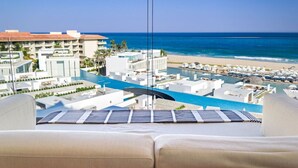 Een resort met een zwembad, strand en uitzicht op de oceaan.