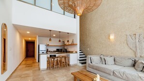 A modern interior with a kitchen, dining area, and living room.