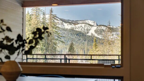 A room with a large window overlooking a snowy mountain landscape. - Government Camp Condo: Ski-in/Ski-out, Mountain Views, Walk to Downtown (Government Camp)