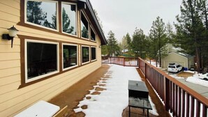 A two-story building with large windows and a wooden deck. - Close to Lake, High Ceilings, Huge Balcony. 2200SF

 (Big Bear Lake)