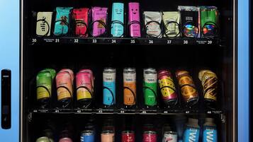 A vending machine stocked with various snacks and beverages.