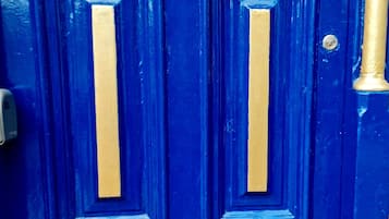 A blue door with two numbers, 259 and 261, indicating apartment numbers.