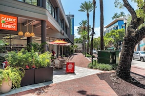 Un edificio comercial con un letrero que dice 'CARROT EXPRESS' y un letrero que dice 'GOOD MORNING COCONUT GROVE'.
