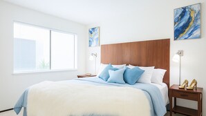 A bedroom with a large bed, a wooden headboard, two bedside tables, and artwork on the walls. - Spacious 3 BR 2B House Sunnyvale Park (Sunnyvale)