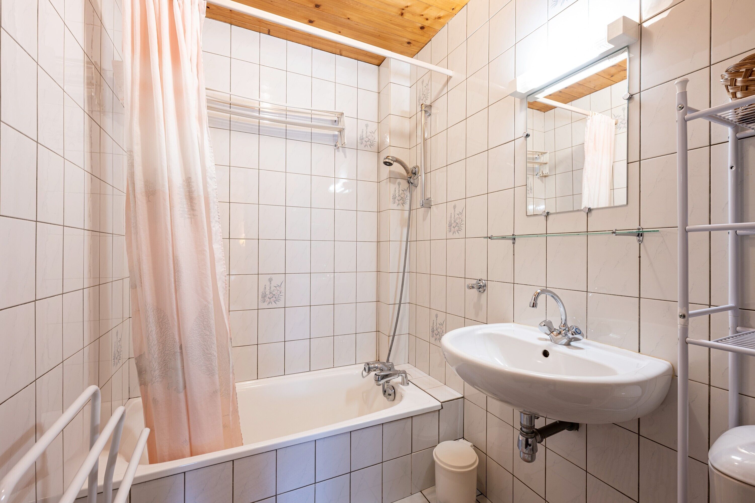 A bathroom with a bathtub, a sink, a shower, and a toilet.