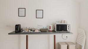 A kitchenette with a coffee maker, microwave, kettle, and framed certificates on the wall. - Room 'Camera 3' with Balcony, Wi-Fi and Air Conditioning (San Giuseppe Jato)