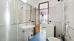 A bathroom with a sink, mirror, and shower. - Amalfi Room with Sea View (Furore)