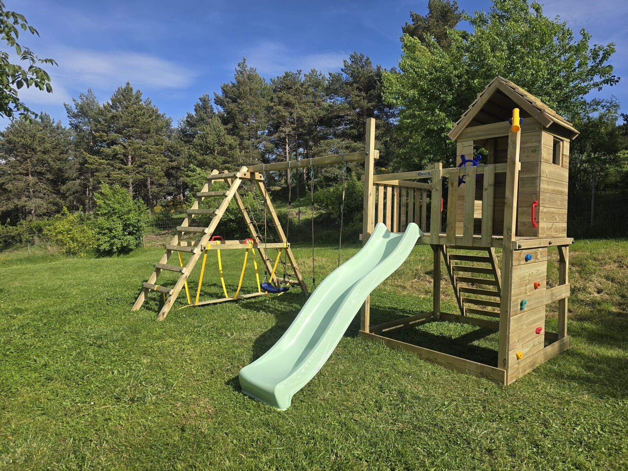 A playground with a slide and climbing structure.