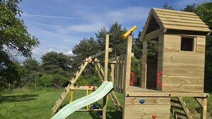 A wooden play structure with a slide and climbing elements. - Country House 'Can Caubet Lll' with Mountain View, Shared Pool and Wi-Fi (Capolat)