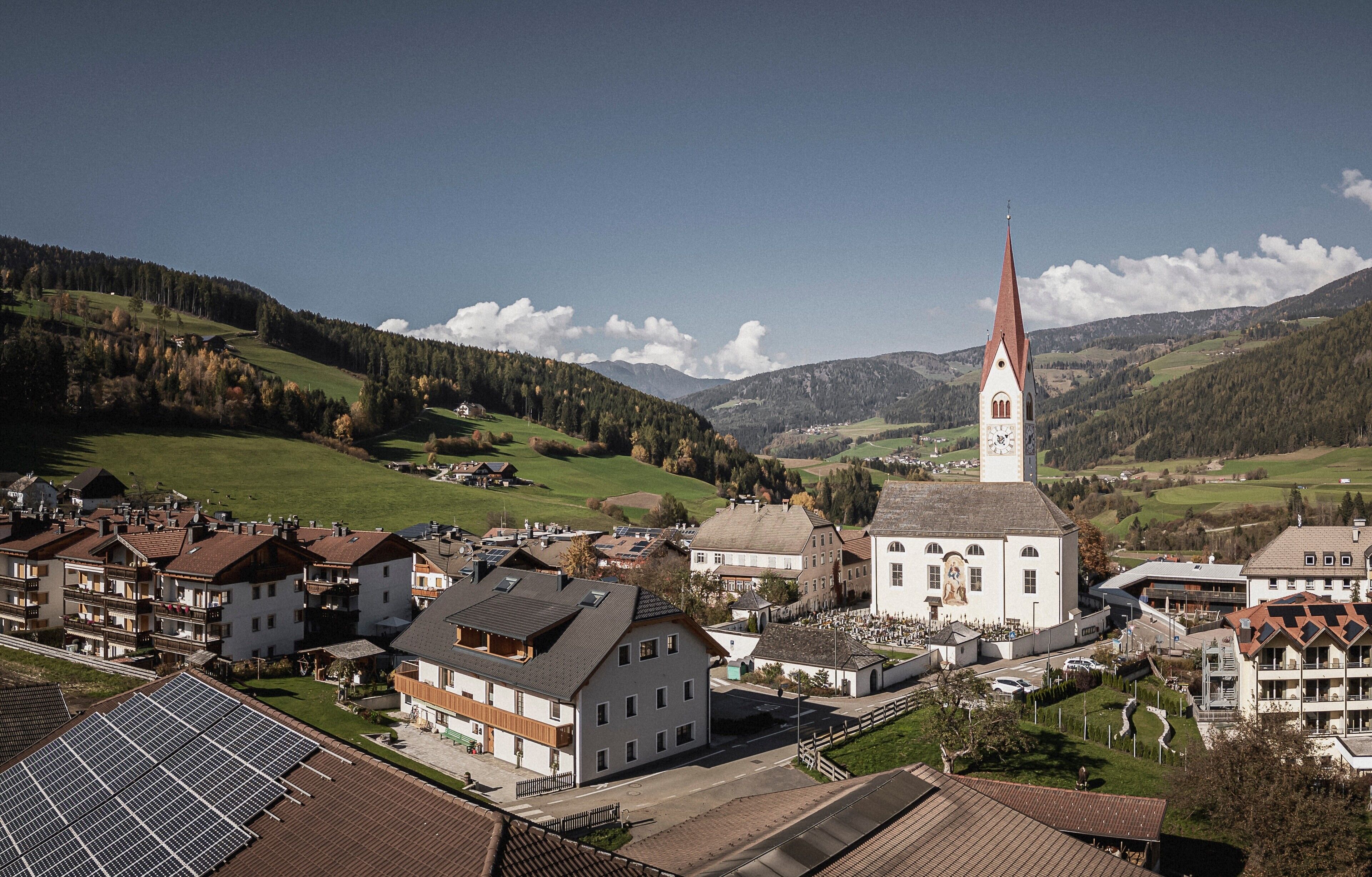 En stad med en framträdande kyrka, bostadshus och en fri utsikt över de omgivande kullarna.