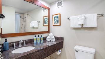 A bathroom with a sink, mirror, towel rack, and toilet.