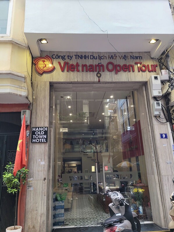 The entrance of Hanoi Old Town Hotel with a sign for Vietnam Open Tour.