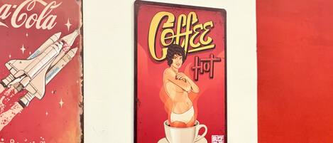 Two vintage signs, one with a space shuttle and the other with a coffee cup illustration.