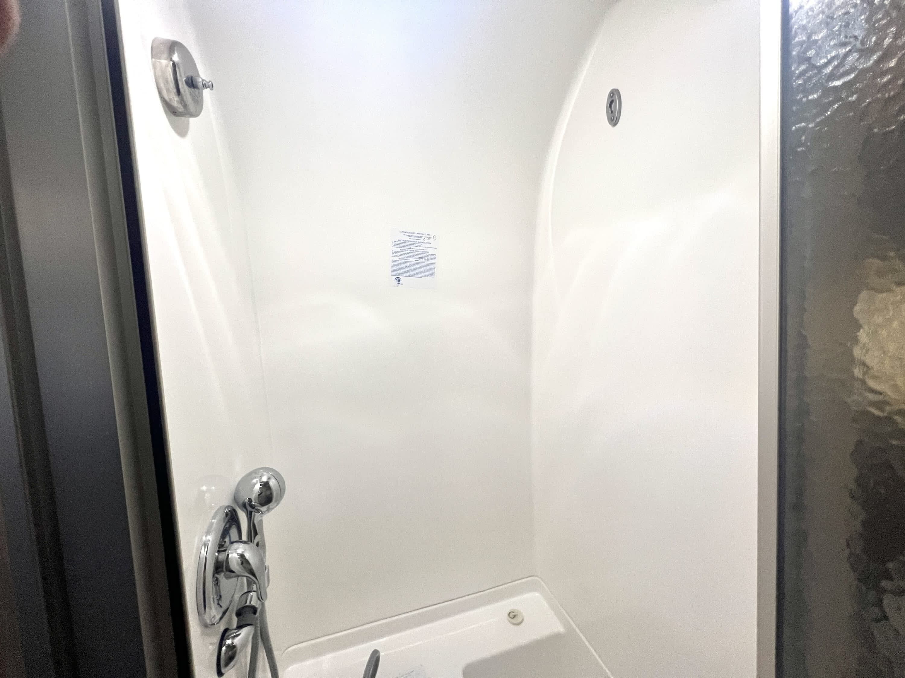Shower, hair dryer, towels, shampoo