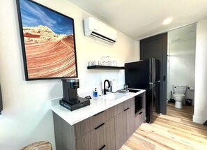 A modern kitchen with a built-in coffee maker, a sink, and a refrigerator. - Valley View Summary: (Orderville)