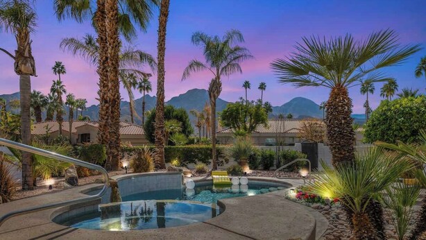 A pool area with multiple hot tubs, surrounded by palm trees and a mountainous backdrop. - 5 Star-Rated Indian Wells 5 Bedroom, Mtn View, Cas (Indian Wells)