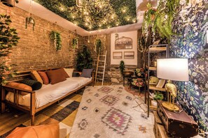 Une pièce chaleureuse avec un lit en bois, un tapis à motifs et un mur en briques.