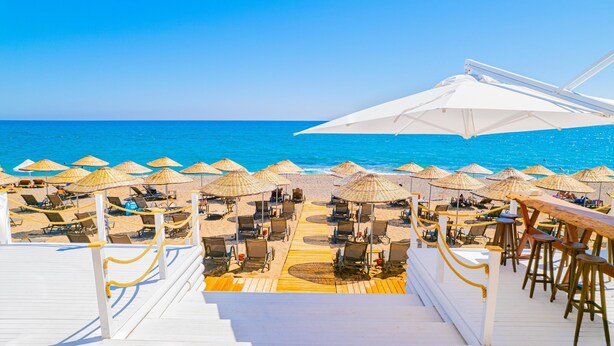A beachside deck with sun loungers and umbrellas, overlooking the sea. - Berry Blue Hotels - All Inclusive (Manavgat)