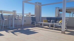 A rooftop terrace with outdoor seating and a pergola structure. - Penthouses Blue Lagoon (VC)