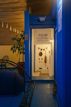 Experience a warm and inviting atmosphere at Andesty's Pequeño Hogar, where a cozy seating area and rustic charm await.