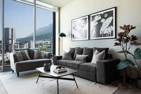 Spacious living area with modern decor and natural light for a relaxing stay