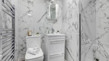 Shower, hair dryer, towels, soap