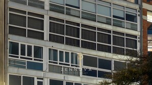 A multi-story building with large windows and balconies, featuring signage for 'ENGELVOLKERS' and 'ZENOVA'. - Nero Luxury Suites by Zennova (Thessaloniki)