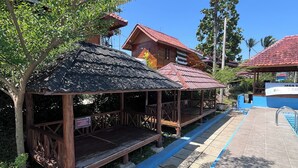 A wooden structure with a tiled walkway and a pool area. - Pondok Cilega (Mandirancan)