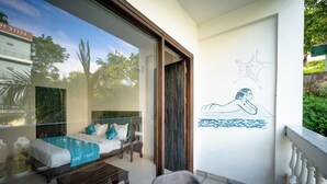 A balcony with a glass door leading to a bedroom with a bed, a small table, and a view of a swimming pool. - Hotel Rishikesh Grand by Kool-stays (Rishikesh)