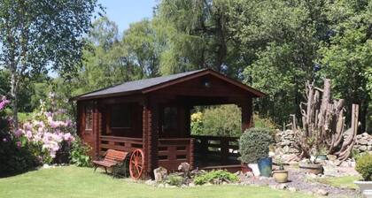 Idyllic countryside haven with lush landscape, manicured garden, pond and stream