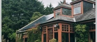 Idyllic countryside haven with lush landscape, manicured garden, pond and stream