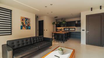 Deluxe Villa, Pool View | Living area | 75-inch Smart TV with satellite channels