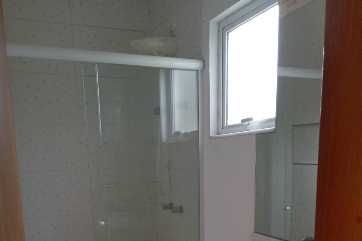A bathroom with a toilet, sink, and shower.