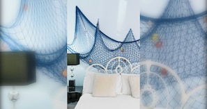 A bedroom with a white bed, a white headboard, and a decorative wall hanging. - Seaside Charm: Next to The Pier, Top Attractions (Brighton and Hove)
