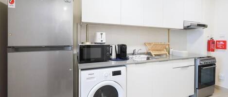 Coffee/tea maker, fridge, microwave, oven