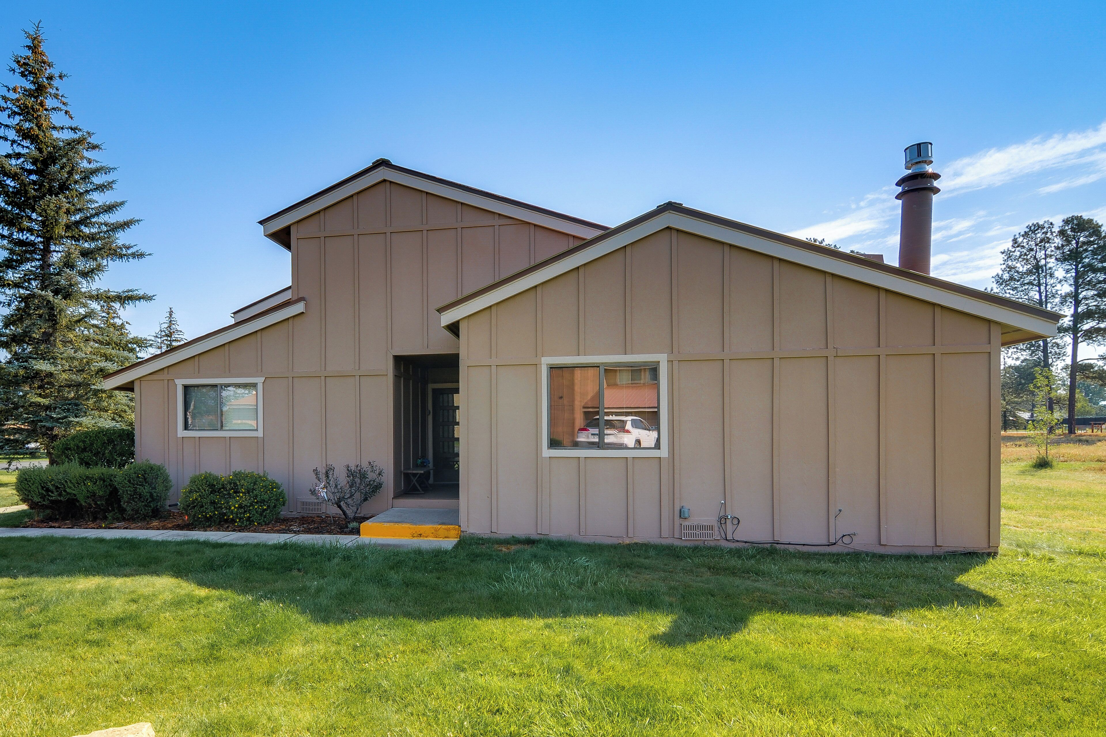 A single-story building with a flat roof, a chimney, and a small porch.