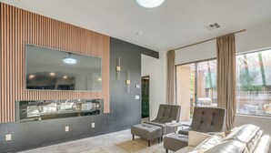 A modern living room with a large mirror, a sofa, two armchairs, and a coffee table. - Relax Poolside! Home 6 Mi to Camelback Ranch (Litchfield Park)