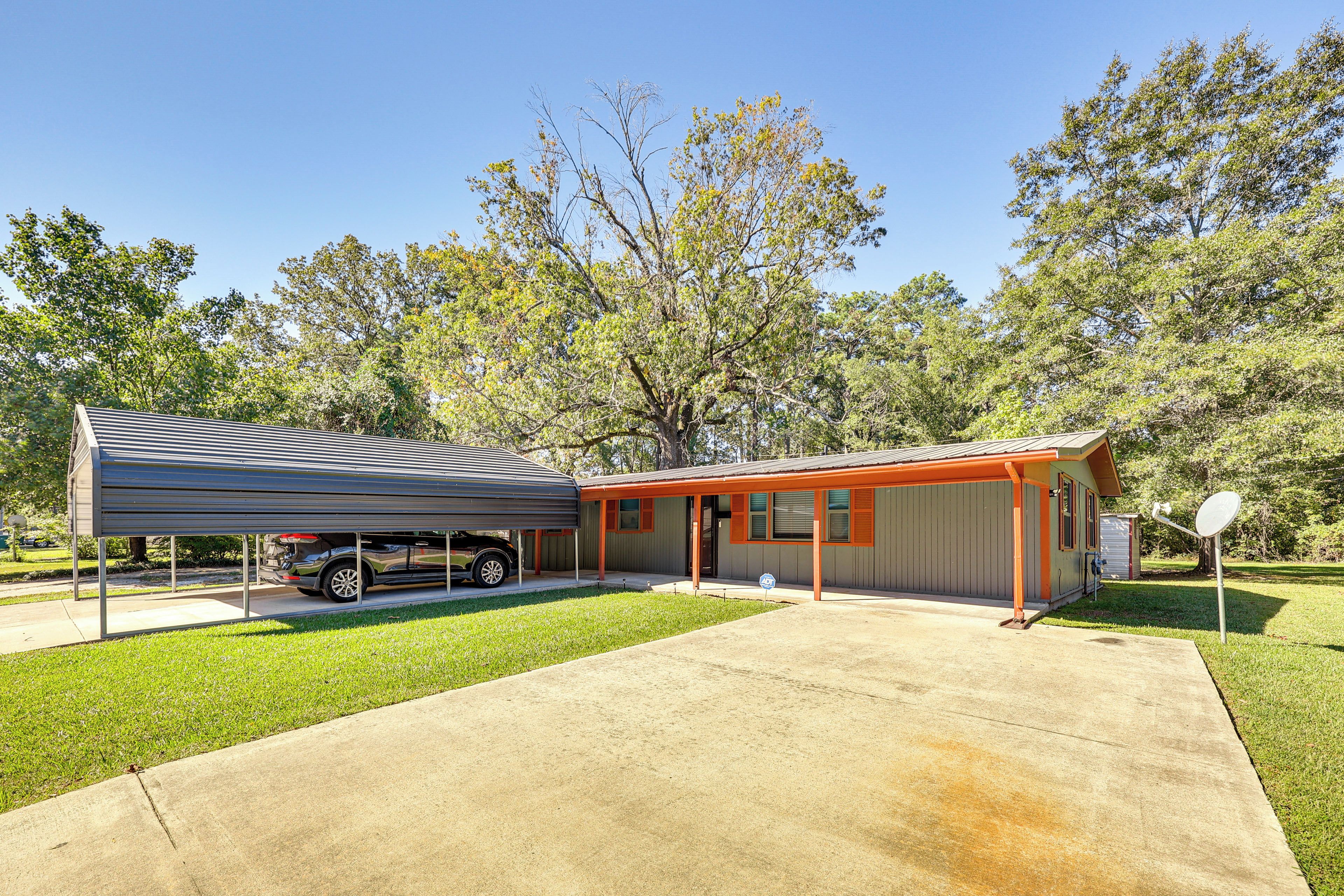 A single-story building with a covered garage and a satellite dish.
