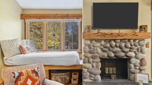 A cozy room with a bed, a window with a view of trees, a fireplace with a stone surround, and a mounted television. - Outpost: Columbine 1024 - Aspens Location! (Wilson)