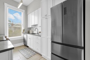 Fridge, microwave, oven, stovetop - Bright + Airy Home w/ Private Parking in Victorian District by Lucky Savannah (Savannah)