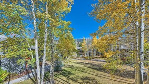 A residential area with trees, a clear sky, and houses in the background. - 1147 Flying Dutchman 1 Bedroom Condo (Keystone)