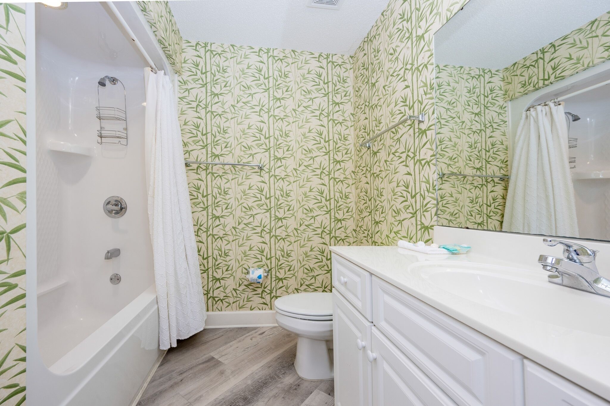 A bathroom with a bathtub, toilet, and sink.