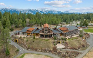 Un grand chalet doté d’un bâtiment central, de nombreuses chambres d’hôtes et d’un espace extérieur couvert.