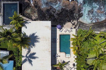 Aerial view of a private pool by the ocean.