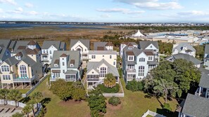A coastal residential area with houses featuring gabled roofs and multiple stories.