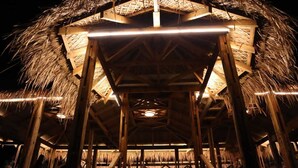 A thatched-roof structure with wooden beams and a central light fixture. - Sinbad Beach Resort (Saint Martin's Island)
