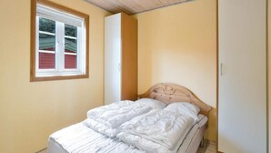 A bedroom with a bed, a window, and a wardrobe. - 4 Person Holiday Park Home in Graested (Graested)