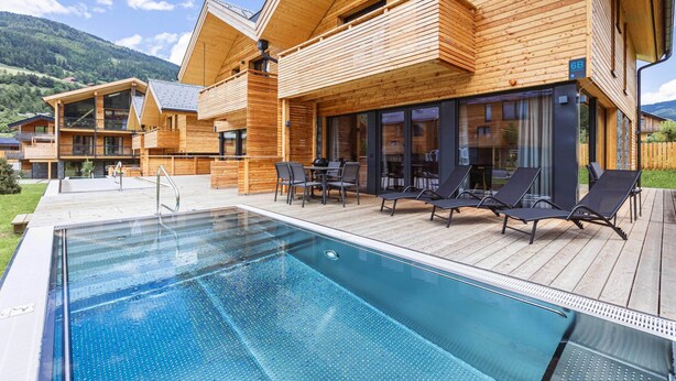 A modern wooden building with a pool and outdoor seating. - Attractive Holiday Home With Pool (Sankt Georgen am Kreischberg)