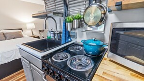 A compact kitchenette with a stove, sink, and oven. - Super Cozy Studio Near Slopes And Shuttle Bus WiFi (Snowshoe)